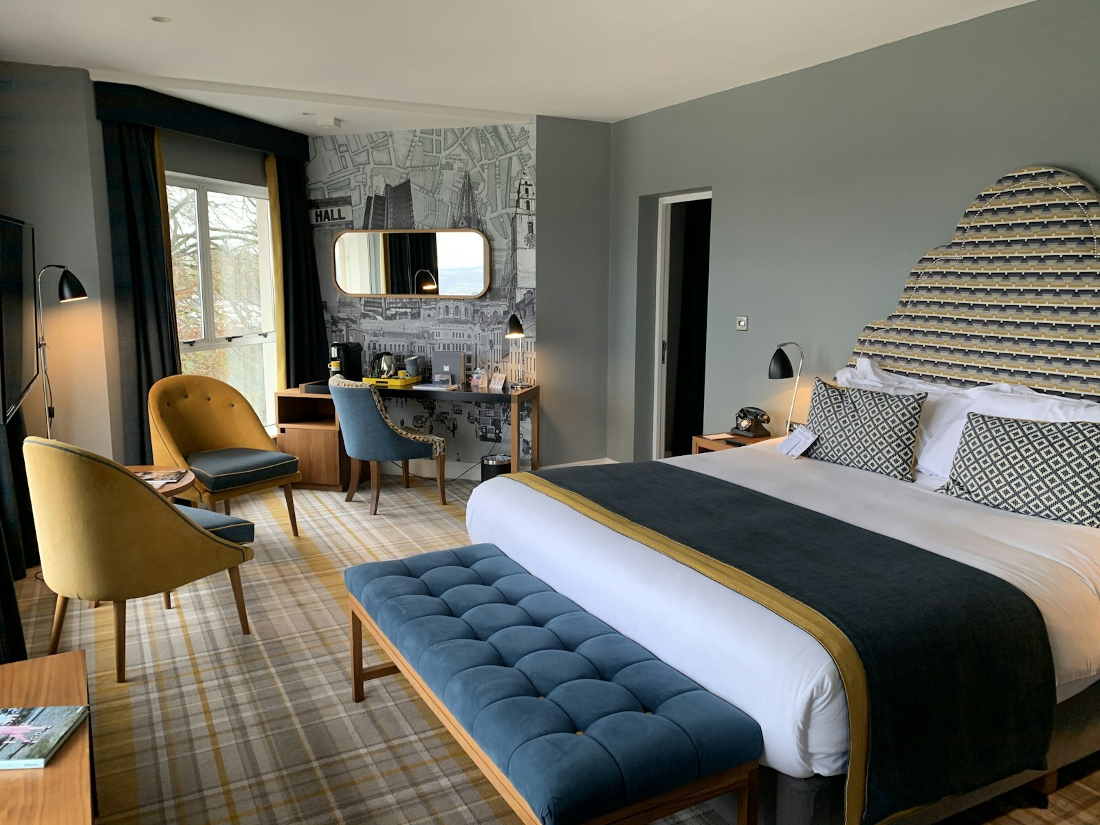 Junior Suite with sitting area and wide windows toward the peaks